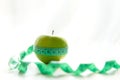 Close up fresh apple and tape measure. Royalty Free Stock Photo