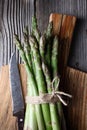 Close up of fresh asparagus sprouts on wooden board Royalty Free Stock Photo
