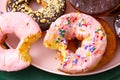 Close up of fresh baked donuts with a bite