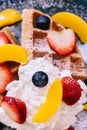 Close up Fresh baked Pancakes topping with strawberry, orange, blueberry and whip cream Royalty Free Stock Photo