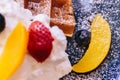 Close up Fresh baked Pancakes topping with strawberry, orange, blueberry and whip cream Royalty Free Stock Photo