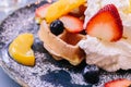 Close up Fresh baked Pancakes topping with strawberry, orange, blueberry and whip cream Royalty Free Stock Photo