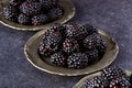 Close up blackberries in plate on dark background Royalty Free Stock Photo