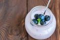 Close up of fresh blueberry yogurt in a jar