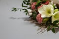 Close-up fresh bouquet of hippeastrum, allium, carnation, ruscus, genista, cotton on a gray background, selective focus