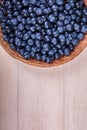 Close-up of fresh and bright blueberries. Healthy, ripe, raw and bright dark blue berries on a wooden background. Copy space. Royalty Free Stock Photo