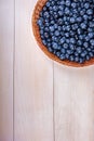 Close-up of fresh and bright blueberry. Healthy, ripe, raw and bright dark blue berries on a wooden background. Copy space. Royalty Free Stock Photo