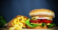 Close up of a fresh cheesburger and french fries Royalty Free Stock Photo