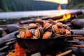 close-up of fresh clams next to campfire