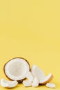 Close up fresh coconut pieces isolated on a yellow background, tropical fruit concept, flat lay, pop art, copy space Royalty Free Stock Photo