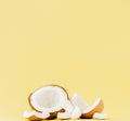Close up fresh coconut pieces  on a yellow background, tropical fruit concept, flat lay, pop art, copy space Royalty Free Stock Photo