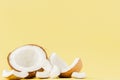 Close up fresh coconut pieces isolated on a yellow background, tropical fruit concept, flat lay, pop art, copy space Royalty Free Stock Photo
