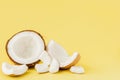 Close up fresh coconut pieces isolated on a yellow background, tropical fruit concept, flat lay, pop art, copy space Royalty Free Stock Photo