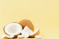 Close up fresh coconut pieces isolated on a yellow background, tropical fruit concept, flat lay, pop art, copy space Royalty Free Stock Photo