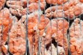 Close-up of fresh coho salmon steaks as a background on a barbecue metal grill - appetizing pieces of fish on an open red fire