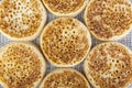 Close up of fresh crumpets on a woven table mat Royalty Free Stock Photo