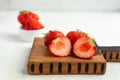 Close up of fresh cut strawberry served on wooden desk on white background Royalty Free Stock Photo