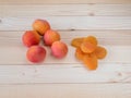 Close up of fresh and driied apricots on wooden background Royalty Free Stock Photo