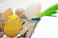 Close-up of fresh food in a basket from a supermarket on a white background. Royalty Free Stock Photo