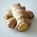 Closeup of a fresh ginger root on a white surface Royalty Free Stock Photo