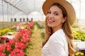 Close-up of fresh girl with straw hat turn to camera in the garden on spring time