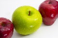 A close up of a fresh green apple between two red apples Royalty Free Stock Photo