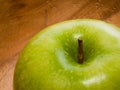 Close-up of fresh green apple on wooden dish