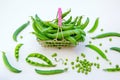 Close up fresh green peas in mini shopping store basket Royalty Free Stock Photo