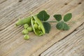 Close-up of fresh green peas on a wooden surface