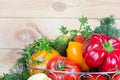 Close up fresh harvested vegetables in wicker basket on wooden table with copy space. Royalty Free Stock Photo