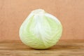 Close-up of fresh head of cabbage on wooden background. Royalty Free Stock Photo