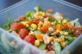 Close up of fresh and healthy salad made with fruits and vegetables in a container. Royalty Free Stock Photo