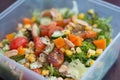 Close up of fresh and healthy salad made with fruits and vegetables in a container. Royalty Free Stock Photo