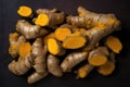 Close-up of a fresh heap of organic turmeric on a black background