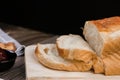 Close up fresh homemade loafs bread and sliced bread on cutting board with jam strawberry on wooden background Royalty Free Stock Photo