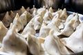 Close up of fresh homemade samosas in kitchen in preparation, samosas are a staple of indian diet and a classic street food