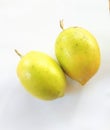 Close-up of fresh lemon fruits in bright yellow color and white background