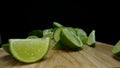 Close-up of fresh lime rests upon a rustic wooden cutting board. Comestible.
