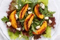 Close-up of fresh mixed salad. Lettuce and arugula leaves with grilled peach and blue cheese