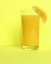 Close Up of Fresh Orange Frozen Granita Slush Drink Garnished with Orange Wedge and Served in Glass with Striped Straw on