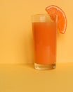 Close Up of Fresh Orange Frozen Granita Slush Drink Garnished with Orange Wedge and Served in Glass with Striped Straw on