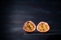 Close-up of a fresh passion fruit half isolated on a dark wood background. copy space for text Royalty Free Stock Photo