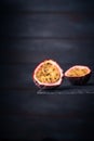 Close-up of a fresh passion fruit half isolated on a dark wood background. copy space for text Royalty Free Stock Photo