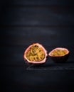 Close-up of a fresh passion fruit half isolated on a dark wood background. copy space for text Royalty Free Stock Photo