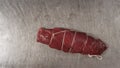 Close up of fresh piece of red meat. Scene. Top view of piece of meat tied with food rope