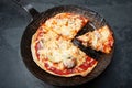 Close up of a fresh Pizza in an rustic iron Pan Royalty Free Stock Photo