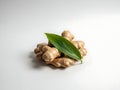 Fresh raw ginger root with green leaves on neutral background fresh ginger organic ginger Royalty Free Stock Photo