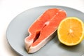 Close up fresh raw salmon steak with lemon slice isolated on white background Royalty Free Stock Photo