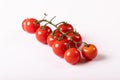 Close-up of fresh red cherry tomatoes twig against white background Royalty Free Stock Photo