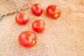 Close up Fresh red tomato on grunged sack background